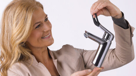  Woman holding the one handle tap